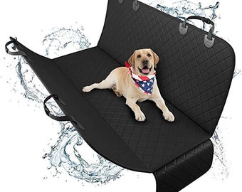May include: Black quilted car seat cover with adjustable straps and handles. A tan Labrador Retriever wearing a red, white, and blue bandana is lying on the cover. Water splashes are in the background.