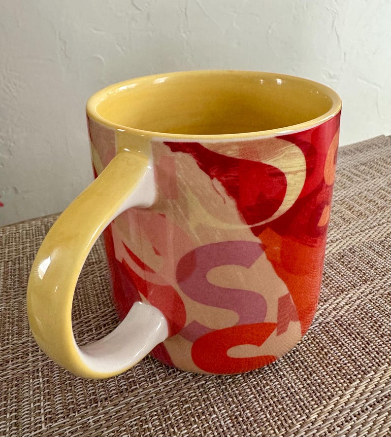 May include: A set of three ceramic mugs with a speckled, matte finish. The mugs are in shades of cream, light gray, and dark gray. Each mug has a simple, minimalist design, perfect for coffee or tea.