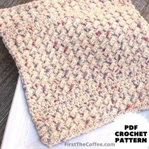 May include: A close-up of a crocheted kitchen dishcloth in a beige color with a speckled pattern of pink, purple, and green yarn. The dishcloth is sitting on a white plate. The text "PDF CROCHET PATTERN" is visible in the lower right corner of the image.