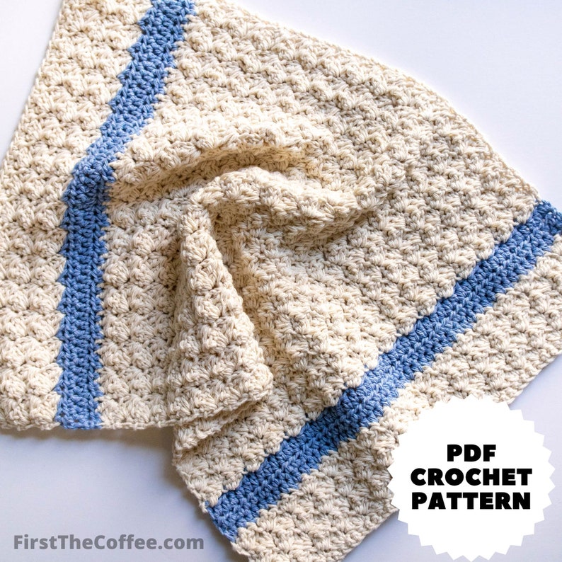 May include: A crocheted baby blanket in cream with two blue stripes. The blanket is folded and has a "PDF CROCHET PATTERN" label in the bottom right corner.
