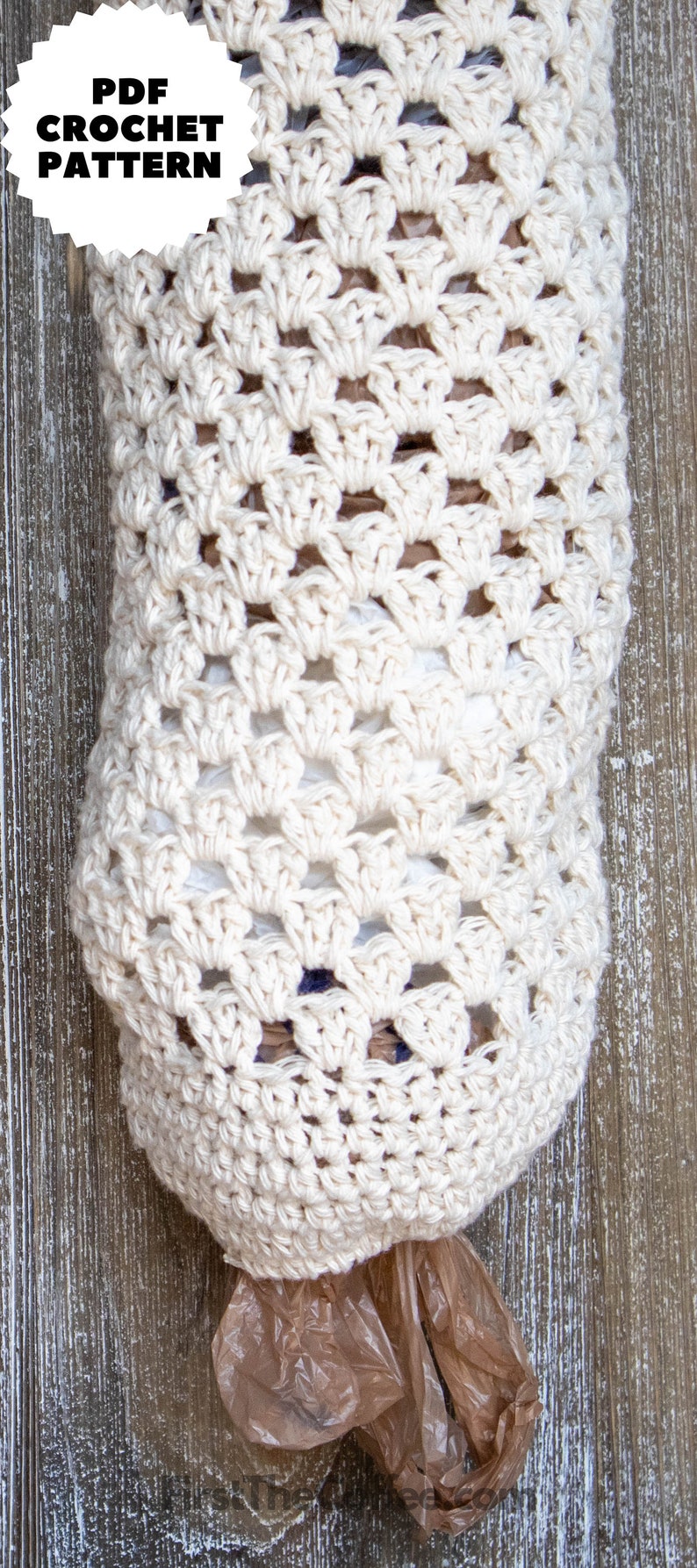 May include: A crocheted bag made with white yarn, designed to hold plastic grocery bags. The bag is hanging on a wooden surface.