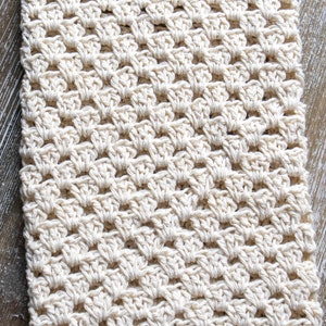 May include: A close-up of a crocheted beige blanket with a "PDF CROCHET PATTERN" label in the top left corner.