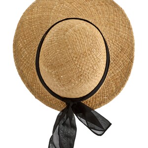 May include: A straw hat with a wide brim and a black ribbon tied at the back. The hat is made of woven straw and has a natural color.