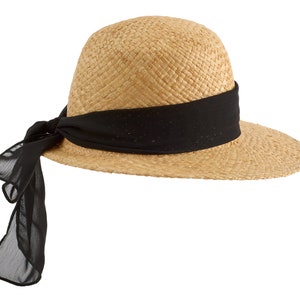 May include: A straw hat with a wide brim and a black ribbon tied around the crown. The ribbon is tied in a bow at the back of the hat.
