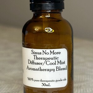 May include: A brown glass bottle with a black cap, labeled "Sinus No More Therapeutic Diffuser/Cool Mist Aromatherapy Blend 100% pure therapeutic grade oils 30mL".