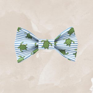 May include: A blue and white striped bow tie with a pattern of green sea turtles.