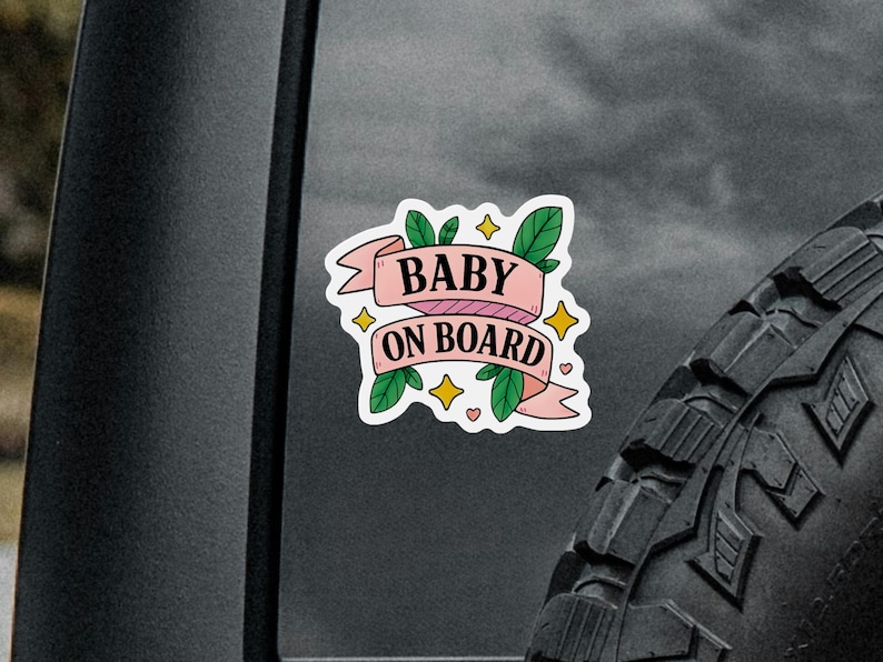 Pink banner car sign that says Baby On Board in bold letters with cute accents