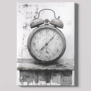 May include: Black and white canvas print of a vintage alarm clock. The clock has a round face with large numbers and two bells on top. It sits on a wooden surface, with a distressed background.
