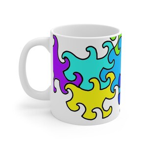 May include: White ceramic mug with a colorful abstract design featuring swirls in shades of purple, blue, turquoise, and yellow.
