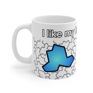 May include: White ceramic mug with a blue and white geometric design. The mug has the text "I like my" printed on it.