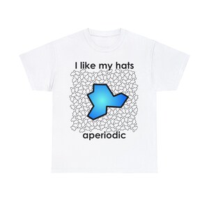 May include: White t-shirt with the text "I like my hats aperiodic" and a blue and black geometric shape.