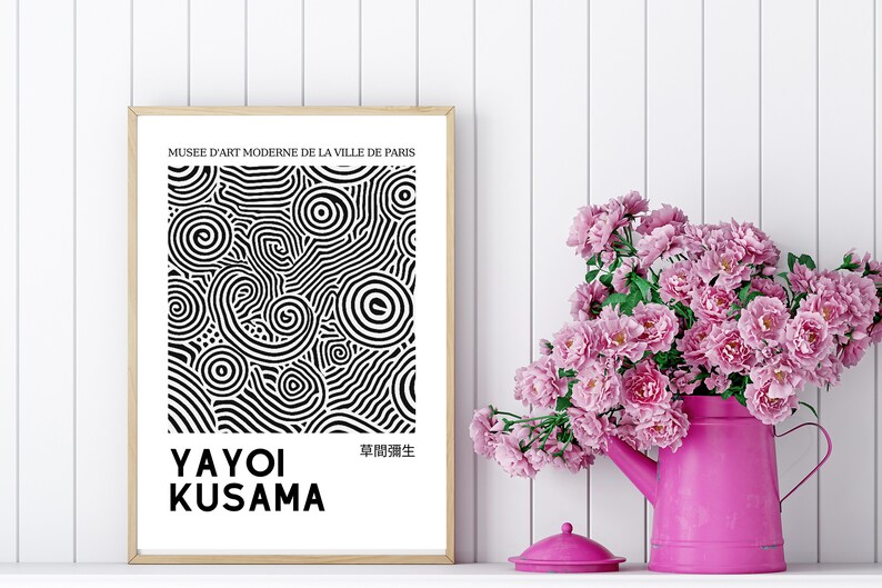 May include: A black and white poster with a swirling abstract design. The poster is framed in a light wood frame and has the text "MUSE&Eacute; D'ART MODERNE DE LA VILLE DE PARIS" at the top and "YAYOI KUSAMA" and "草間彌生" at the bottom.