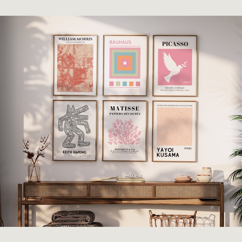 May include: A set of 8 minimalist art prints featuring famous artists and their works. The prints are framed in a light wood frame and are hung on a white wall. The prints include works by William Morris, Bauhaus, Picasso, Matisse, Keith Haring, and Yayoi Kusama.