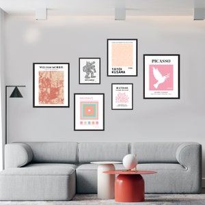 May include: A white wall with eight framed art prints. The prints feature various artists and styles, including William Morris, Yayoi Kusama, Keith Haring, Bauhaus, Matisse, and Picasso. The prints are arranged in a grid pattern.