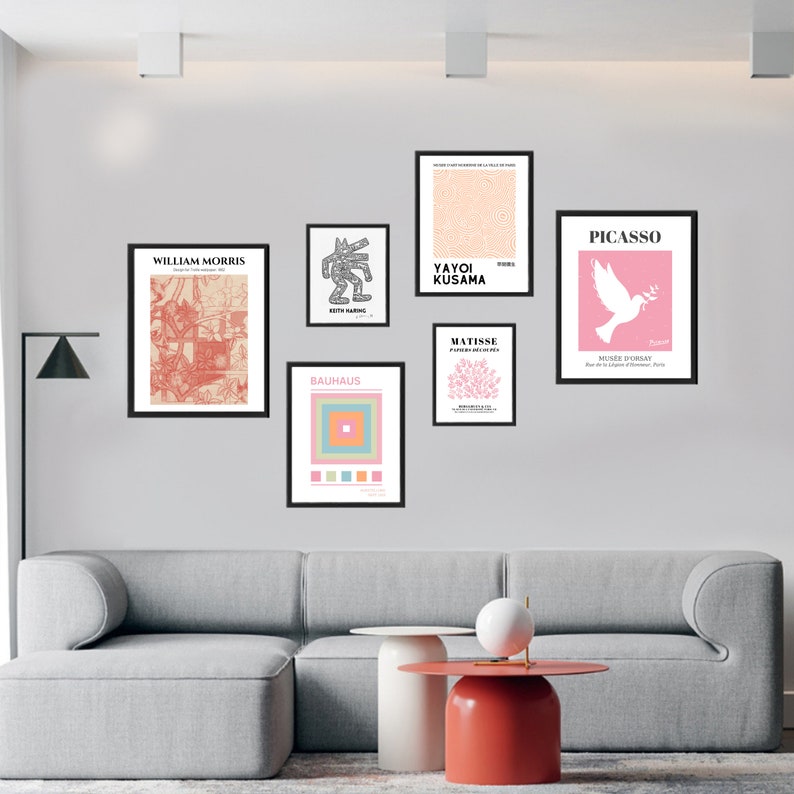 May include: A white wall with eight framed art prints. The prints feature various artists and styles, including William Morris, Yayoi Kusama, Keith Haring, Bauhaus, Matisse, and Picasso. The prints are arranged in a grid pattern.