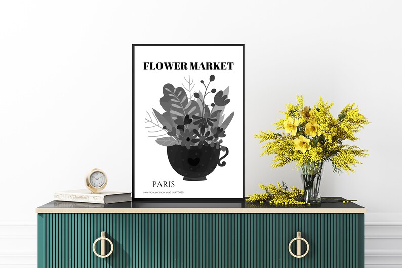 May include: A black and white poster with the text "FLOWER MARKET" and "PARIS" in a modern font. The poster features a stylized illustration of a bouquet of flowers in a black teacup.