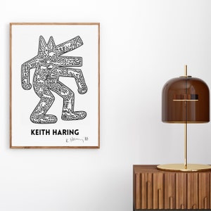 May include: A framed black and white print of a stylised human figure by Keith Haring. The print is signed "K. Haring 88".