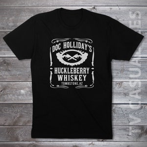 May include: Black t-shirt with a white graphic design of a vintage label for "Doc Holliday's Huckleberry Whiskey" with crossed pistols and the text "Tombstone, AZ."
