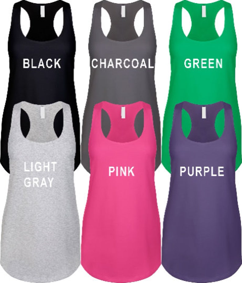 May include: Six tank tops in different colors: black, charcoal, green, light gray, pink, and purple. Each tank top has a scoop neck and racerback style.