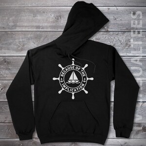 May include: Black hooded sweatshirt with a white graphic of a ship's wheel with the text "Because of the Implication" around it.