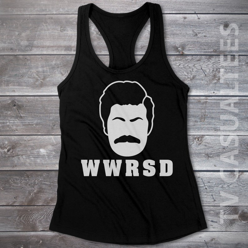 May include: Black tank top with a white graphic of a man's face with a mustache and the text "WWRSD".