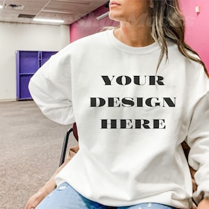 May include: White sweatshirt with the text "YOUR DESIGN HERE" printed in black.