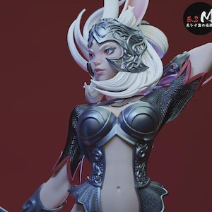 May include: A detailed figurine of a female character with white hair and rabbit ears, wearing a silver helmet and armor. The figure has red eyes and is posed with one arm raised. The background is a solid maroon color.