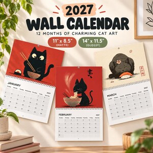 May include: A 2027 wall calendar featuring cat art for January, February, and March. The calendar displays three open pages with illustrations of black cats eating sushi and noodles. Available in 27.9 by 21.6 cm matte or 35.6 by 29.2 cm glossy.