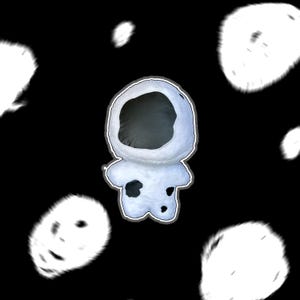 May include: A plush astronaut doll in a cartoon style, with a white body and black spots. The astronaut's helmet is open, revealing a dark interior. The background is black with blurred white shapes.