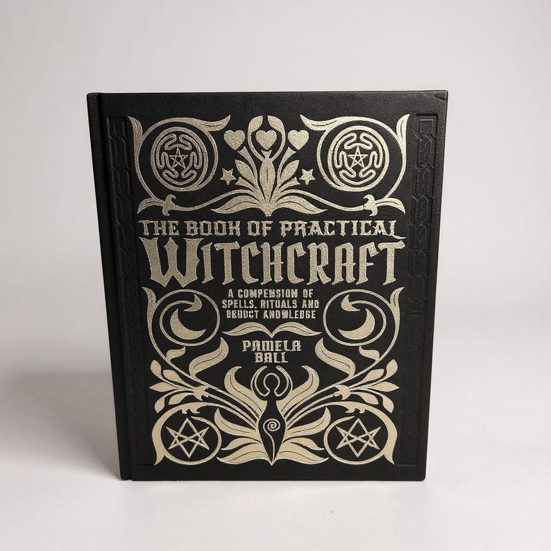 May include: A hardback book with a black cover and gold lettering and embellishments. The title reads "THE BOOK OF PRACTICAL WITCHCRAFT". The cover design includes stars, hearts, and floral patterns. The author is Pamela Ball.