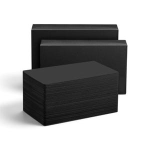 May include: A stack of rectangular black cards positioned in the foreground, with two larger, empty black rectangular boxes placed directly behind the stack. The cards and boxes feature a solid, matte black finish with no visible text or patterns.