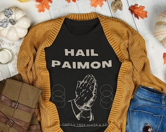 May include: Black t-shirt with the text "HAIL PAIMON" in white lettering. The shirt features a graphic of two hands clasped in prayer with a circle design around them.