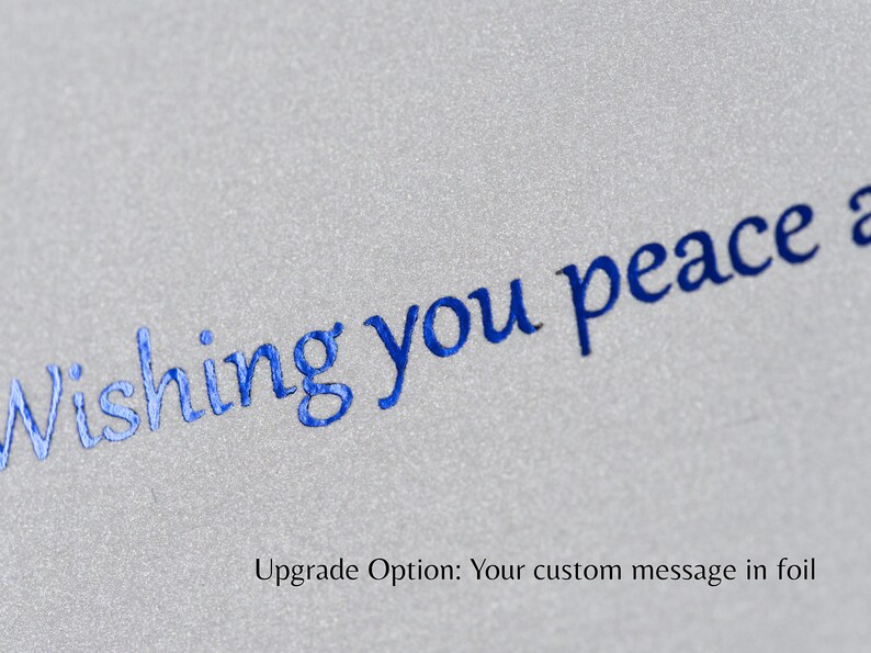 Closeup of an example of custom foil text in blue on metallic cardstock