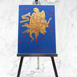 Laser cut paper greeting card with metallic paper and foil accents displayed on mini easel