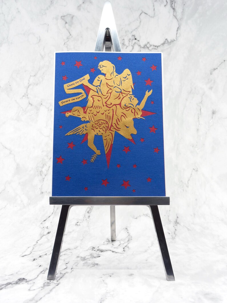 Laser cut paper greeting card with metallic paper and foil accents displayed on mini easel