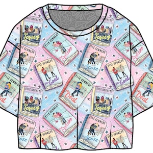 May include: A short-sleeved, round-neck t-shirt featuring a repeating pattern of book covers with titles like "The Score" and "The Goal" by Elle Kennedy. The design includes a pastel color scheme with stars.