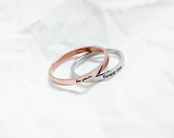 May include: Two thin gold and silver rings with the words "Forever Love" and "Lee Yerin" engraved on them.
