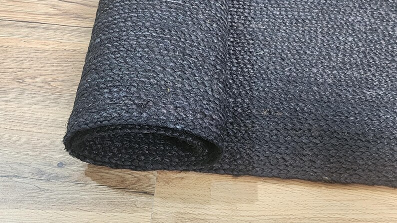 May include: A black rolled up mat with a textured surface.