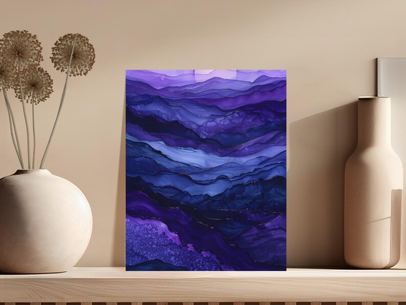 Abstract purple and blue flowing ink art with gold accents on a shelf.