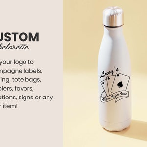 May include: White stainless steel water bottle with a black design that says "Lucy's Vegas Before Vows" with playing cards. The bottle is a popular item for bachelorette parties.