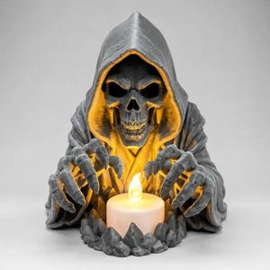 May include: A grey, hooded skeletal figure with outstretched, claw-like hands positioned around a small, glowing white LED tea light candle. The figure features a detailed skull face and draped robes, with warm yellow light illuminating the interior.