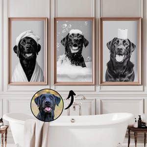 May include: Three framed wall art prints featuring a black Labrador retriever in a bathroom setting. One shows the dog in a towel, one in a bubble bath, and one with a toilet paper roll on its head. A circular inset shows a black Labrador portrait.