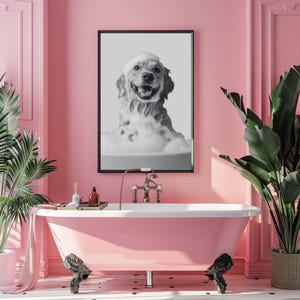May include: A rectangular wall art print featuring a black and white photograph of a dog covered in white soap bubbles, set inside a thin black frame. The dog has an open mouth and appears to be sitting in a bathtub filled with thick foam.