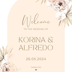 May include: A peach-colored welcome sign with a floral design and the text "Welcome to the wedding of Korina & Alfredo 26.05.2024 Thank you".