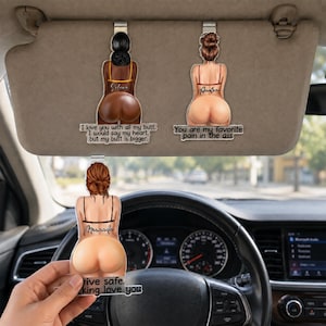 May include: Three car visor ornaments featuring illustrations of figures from behind. The top two hang from a car visor, while the third is held in front of the steering wheel. Each figure has a name and text printed on the base: Selena, Azalea, and Miranda.