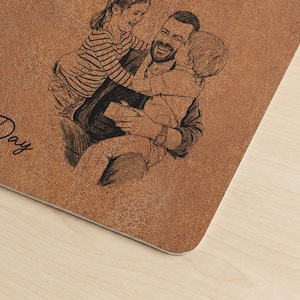 May include: A brown, textured, rectangular item with a sketch of a father and two children. The father is smiling and embracing the children. The word "Day" is visible in the image. The item appears to be a personalized gift.