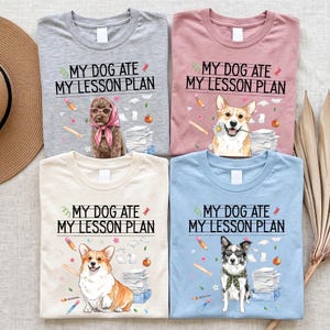 May include: Four t-shirts in gray, pink, cream, and light blue, each featuring the text 'MY DOG ATE MY LESSON PLAN' and illustrations of dogs, pencils, apples, and paper stacks. The dogs include a poodle in a headscarf, a corgi with a flower, a corgi, and a dog with sunglasses and a scarf.