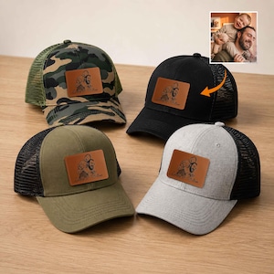 May include: Four baseball caps with mesh backs and leather patches. The caps are in camouflage, black, olive green, and grey. Each patch features a family portrait and the text "Daddy & William".