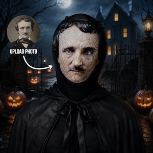 May include: A black hooded cape featuring a custom printed face mask that displays a portrait of Edgar Allan Poe. The mask covers the face with a detailed photographic image, while the black fabric cape ties at the neck with a simple ribbon.