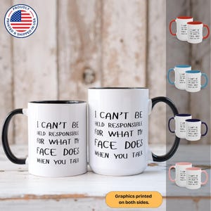 May include: Two white coffee mugs with black rims and handles. The mugs have black text that reads "I can't be held responsible for what my face does when you talk".